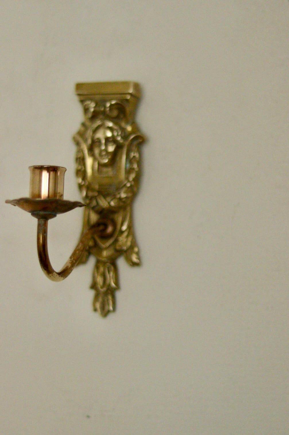 Pair of mid-century Swedish brass face motif sconces