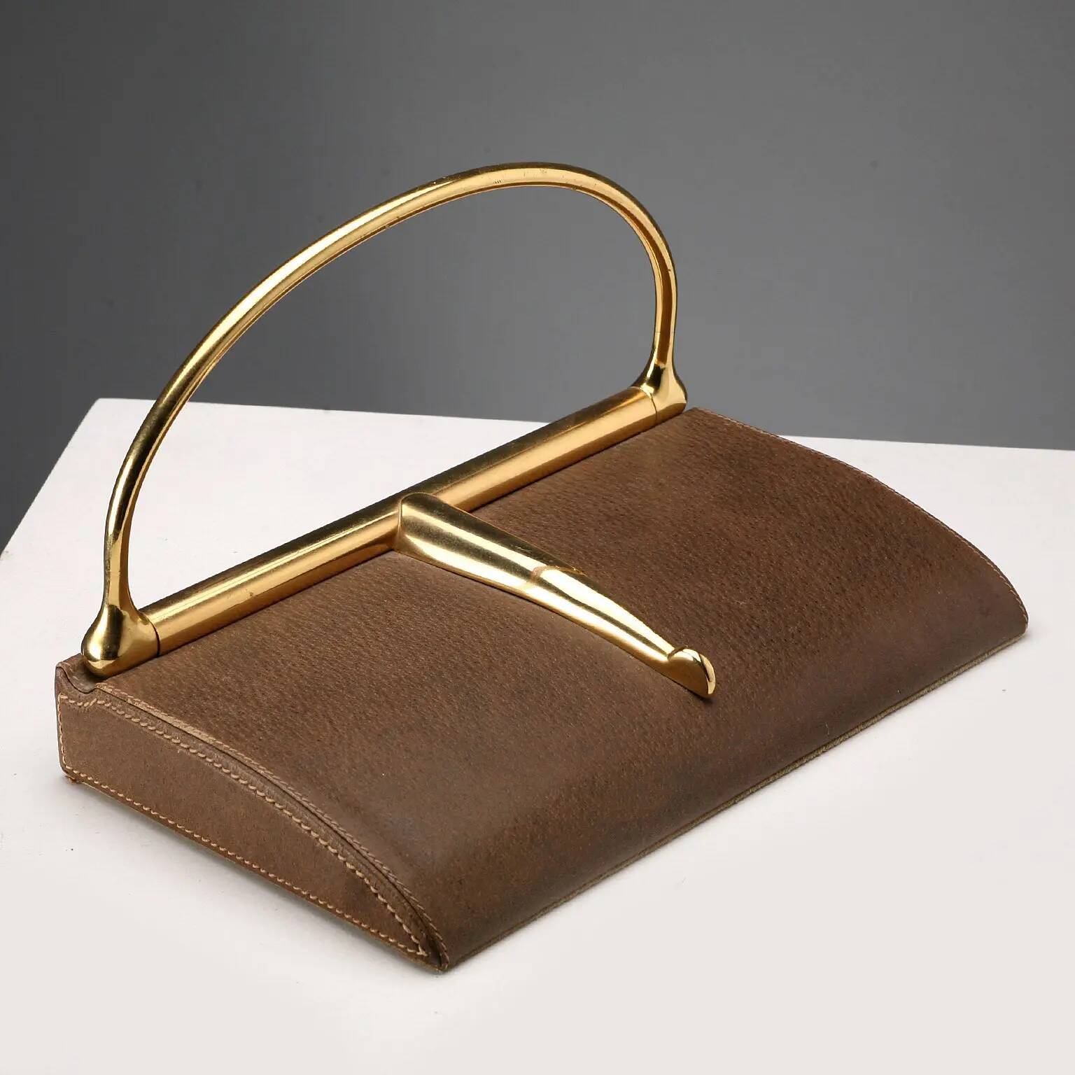 Vintage Gucci bookends in leather and brass, Italy, 1970s.