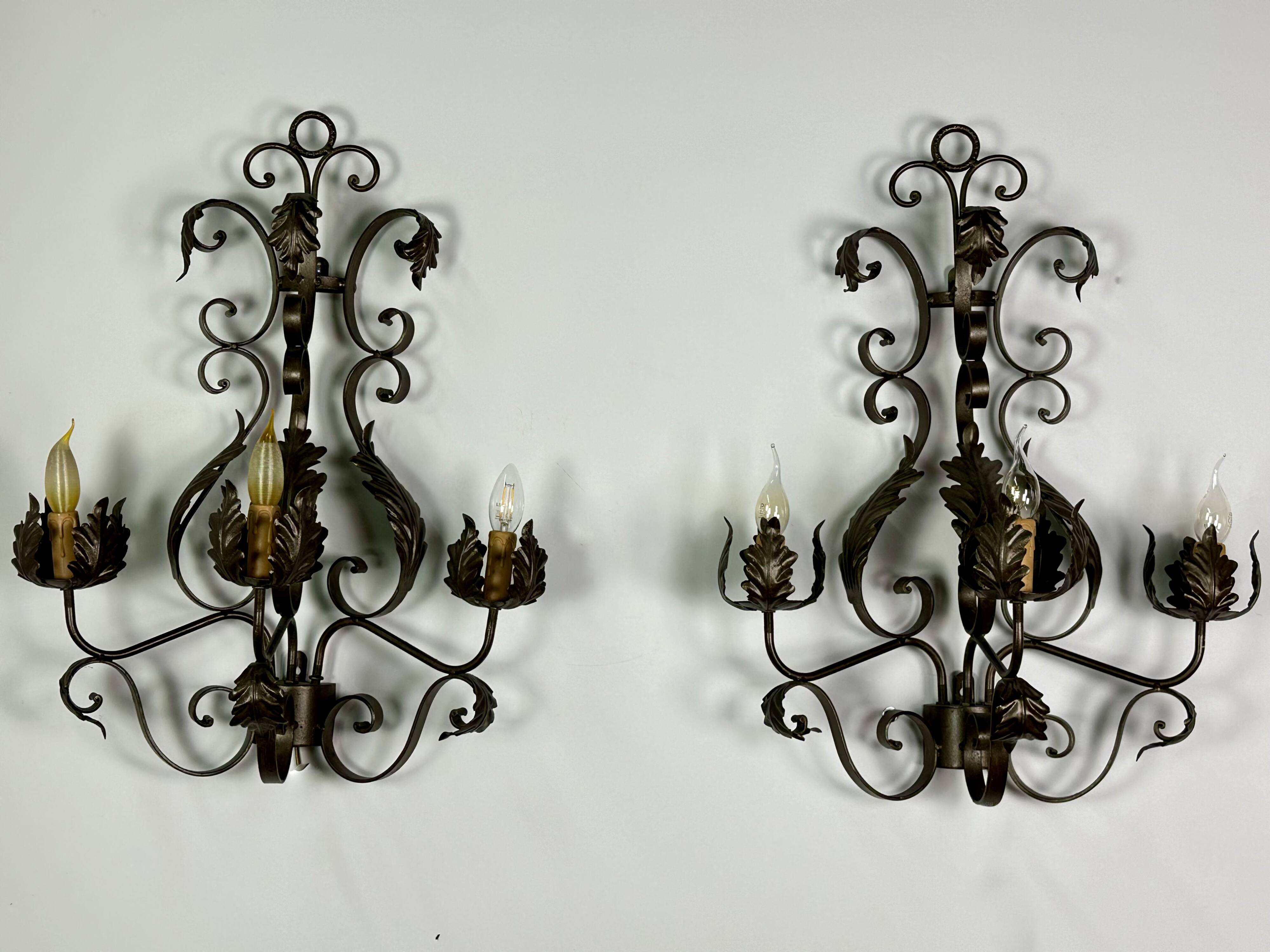 Wrought iron wall lights (pair) with foliage decoration