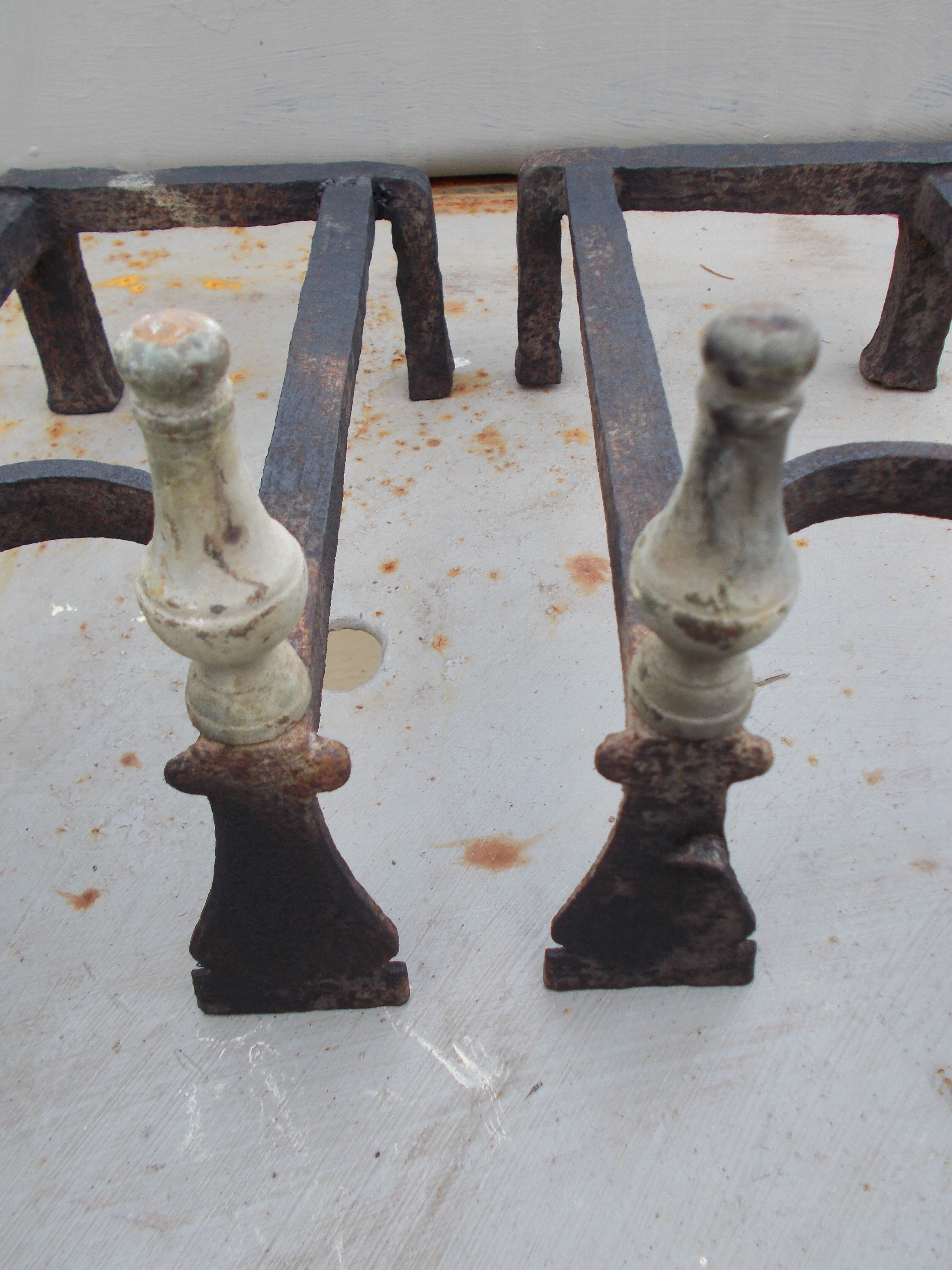 Old pair of wrought iron and bronze pegs