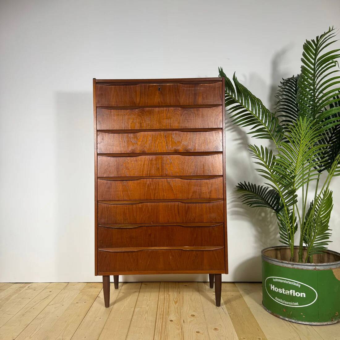 Mid-century Danish high chest of drawers with eight teak drawers.