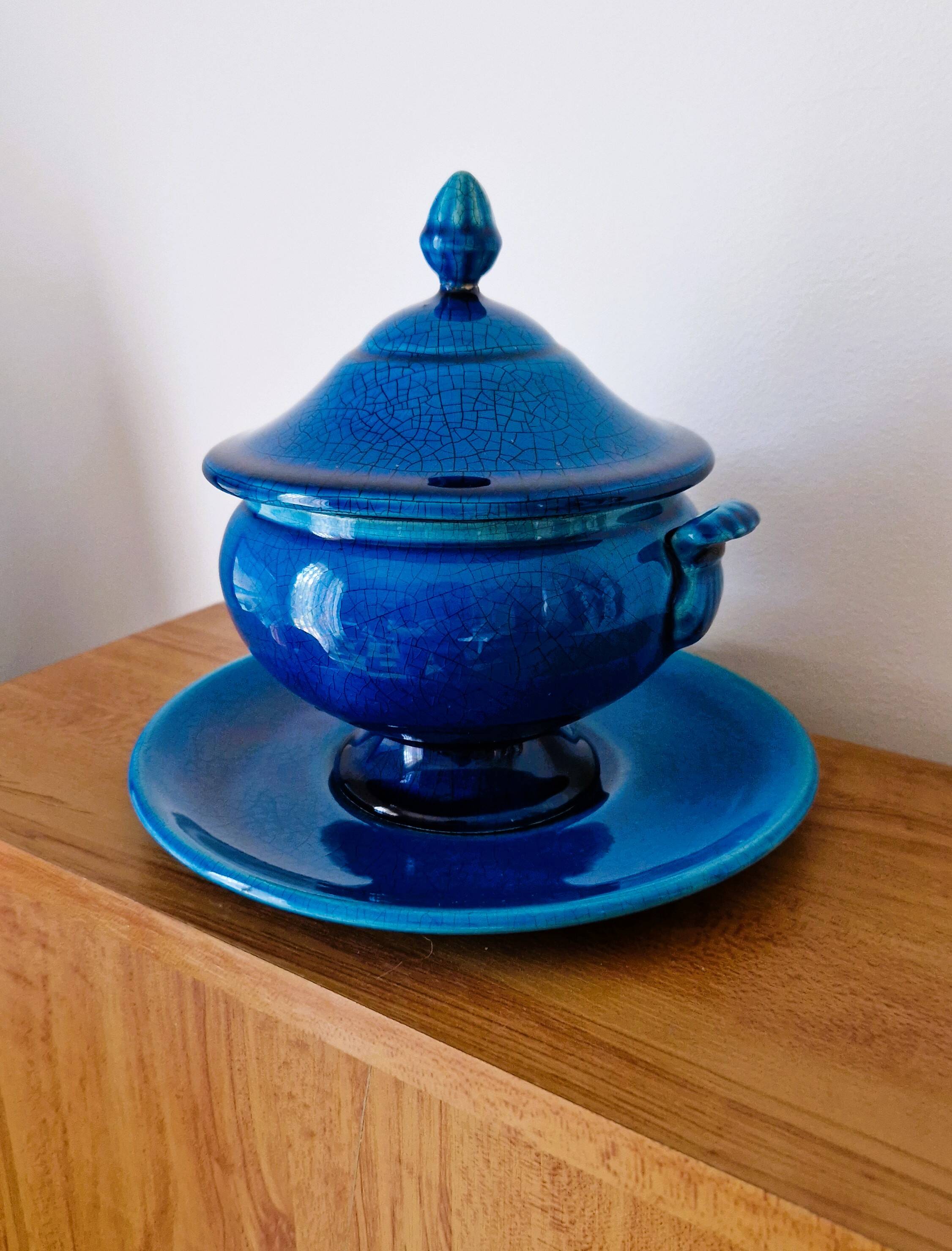 Blue ceramic soup tureen and crackled finish trivet.