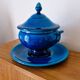 Blue ceramic soup tureen and crackled finish trivet.
