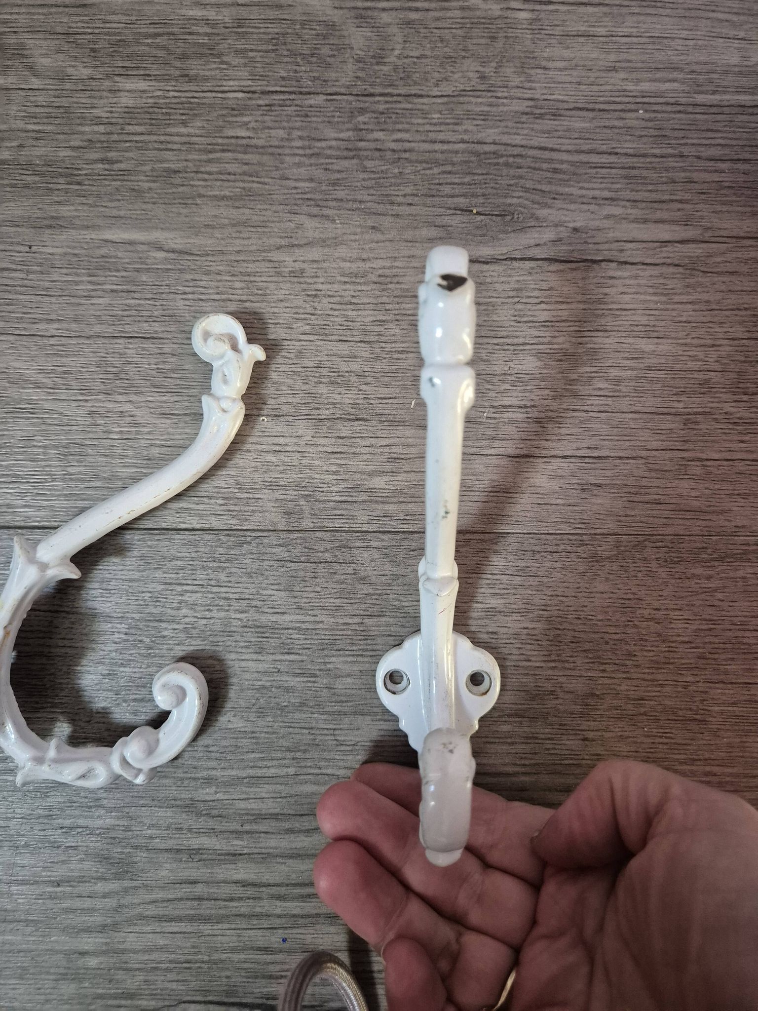 set of 2 vintage white cast iron hooks, small paint chips from the year