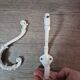 set of 2 vintage white cast iron hooks, small paint chips from the year