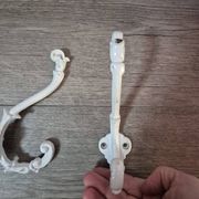 set of 2 vintage white cast iron hooks, small paint chips from the year