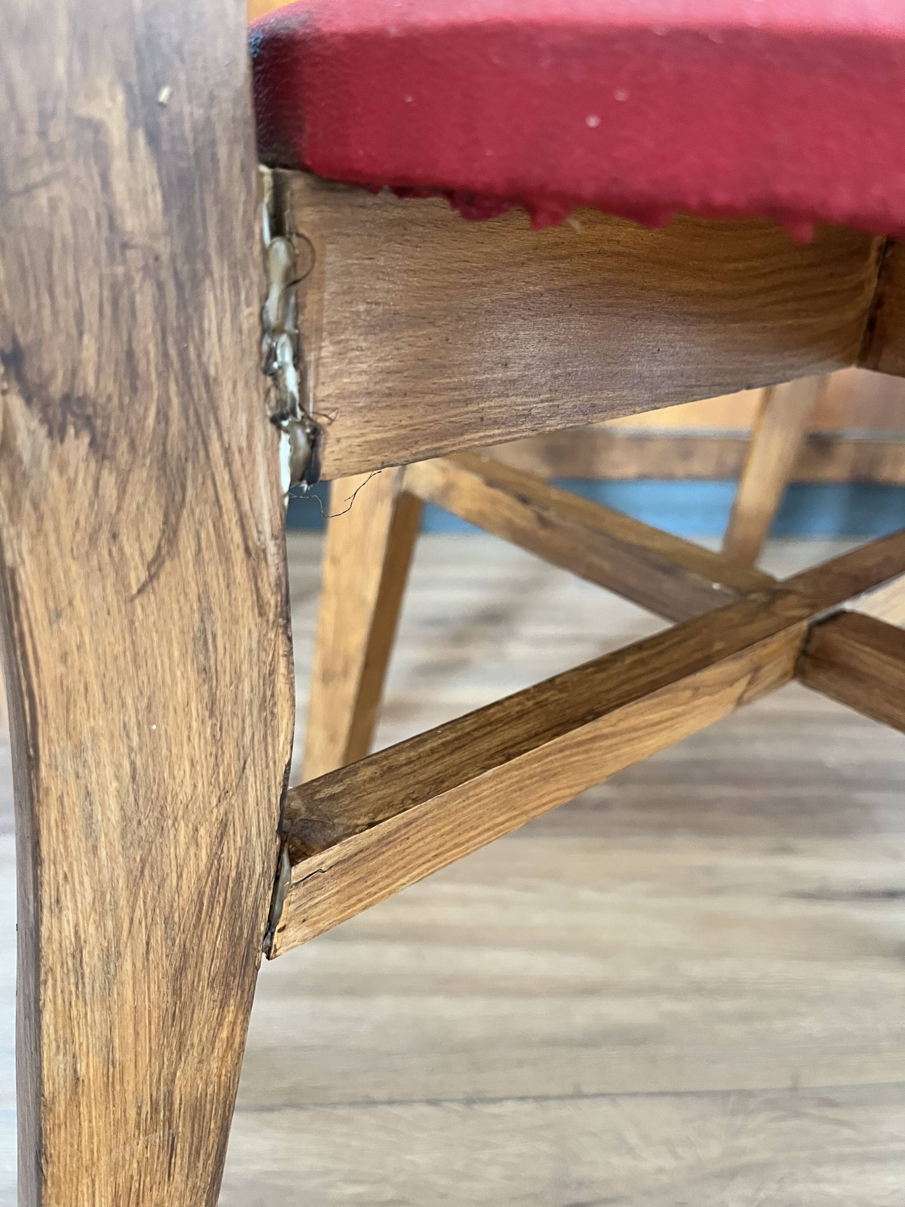 Set of 4 wooden chairs with red vinyl.