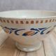 Old ironstone bowl with vintage blue and ochre decoration.
