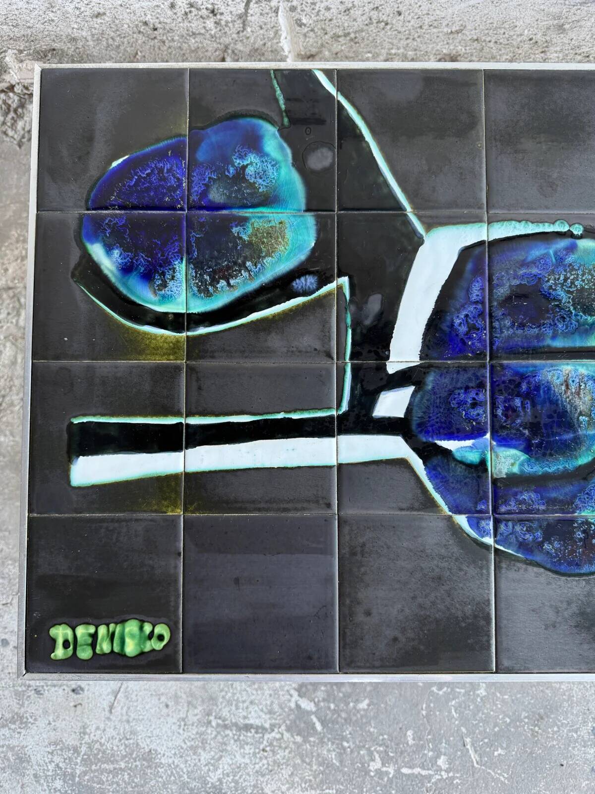 Mid-century Denisco ceramic coffee table — black, blue and white glazed tile top with silver metal base