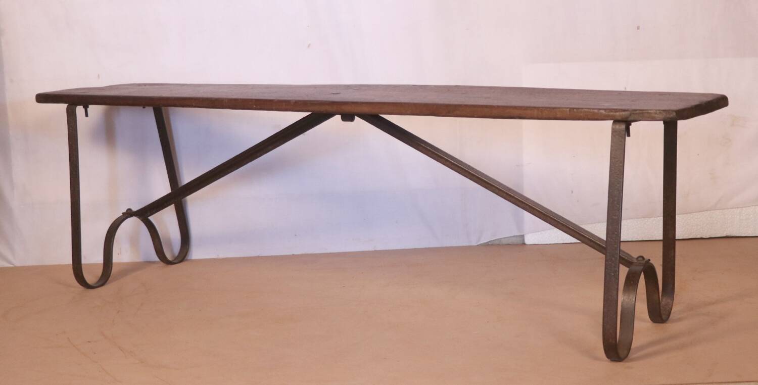 Old bench in Burmese teak with a wrought iron base.