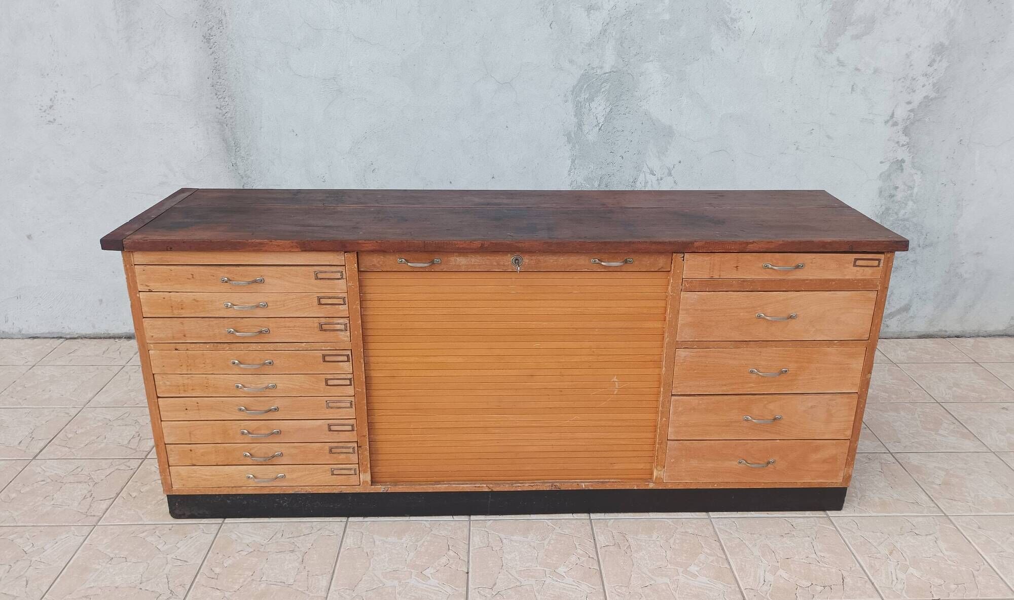 Workshop furniture with drawers and curtain in beech and walnut.