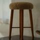 Danish sculptural stool from the mid-century modern period with a lambswool seat, 1960s.