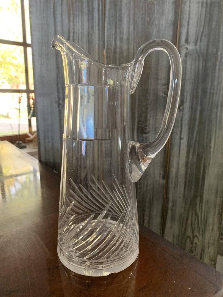 Transparent crystal pitcher, mid-century Hungarian, conical silhouette, sculptural handle and cut decoration.