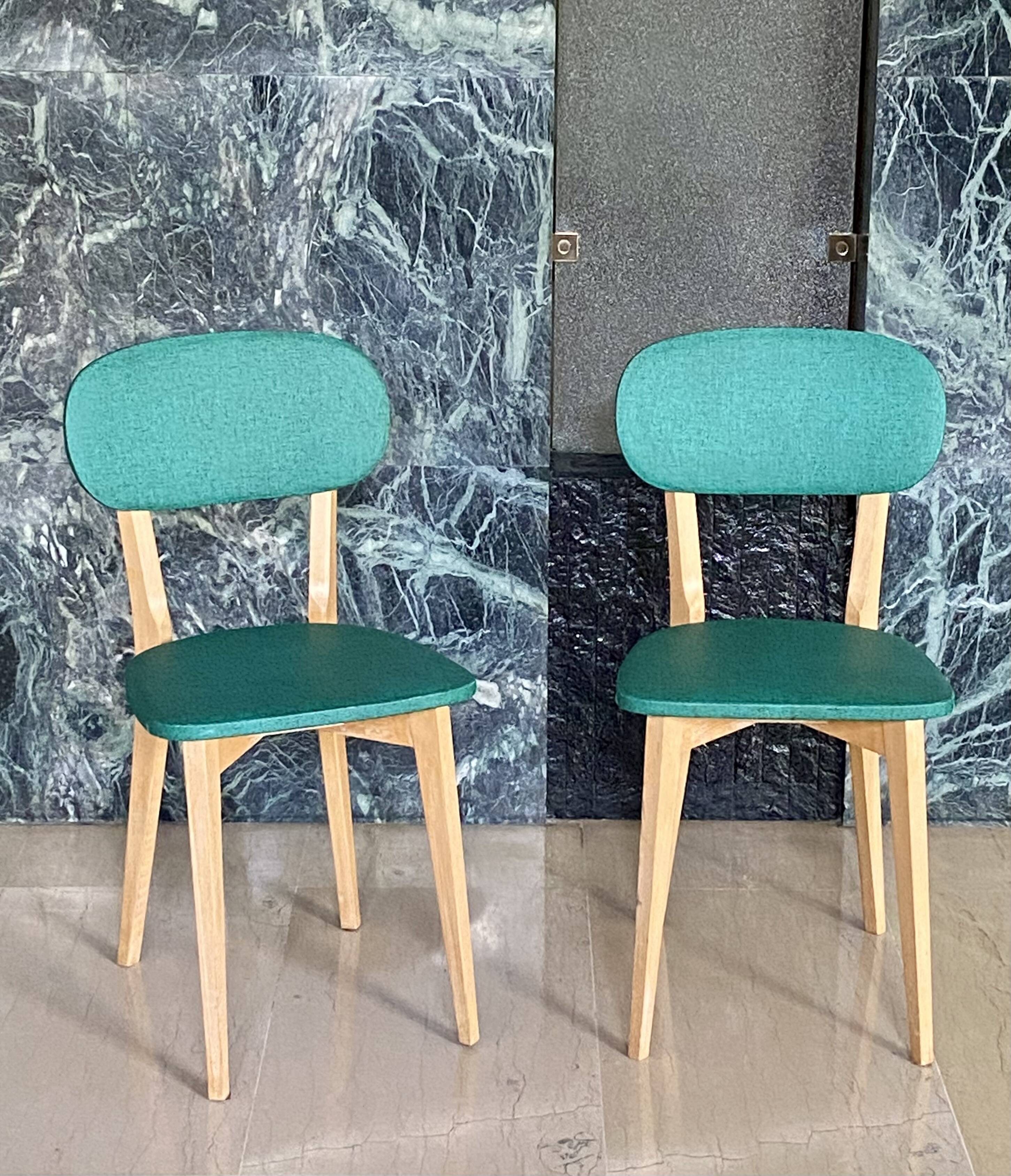 Paire de chaises vintage skaï vert pieds compas