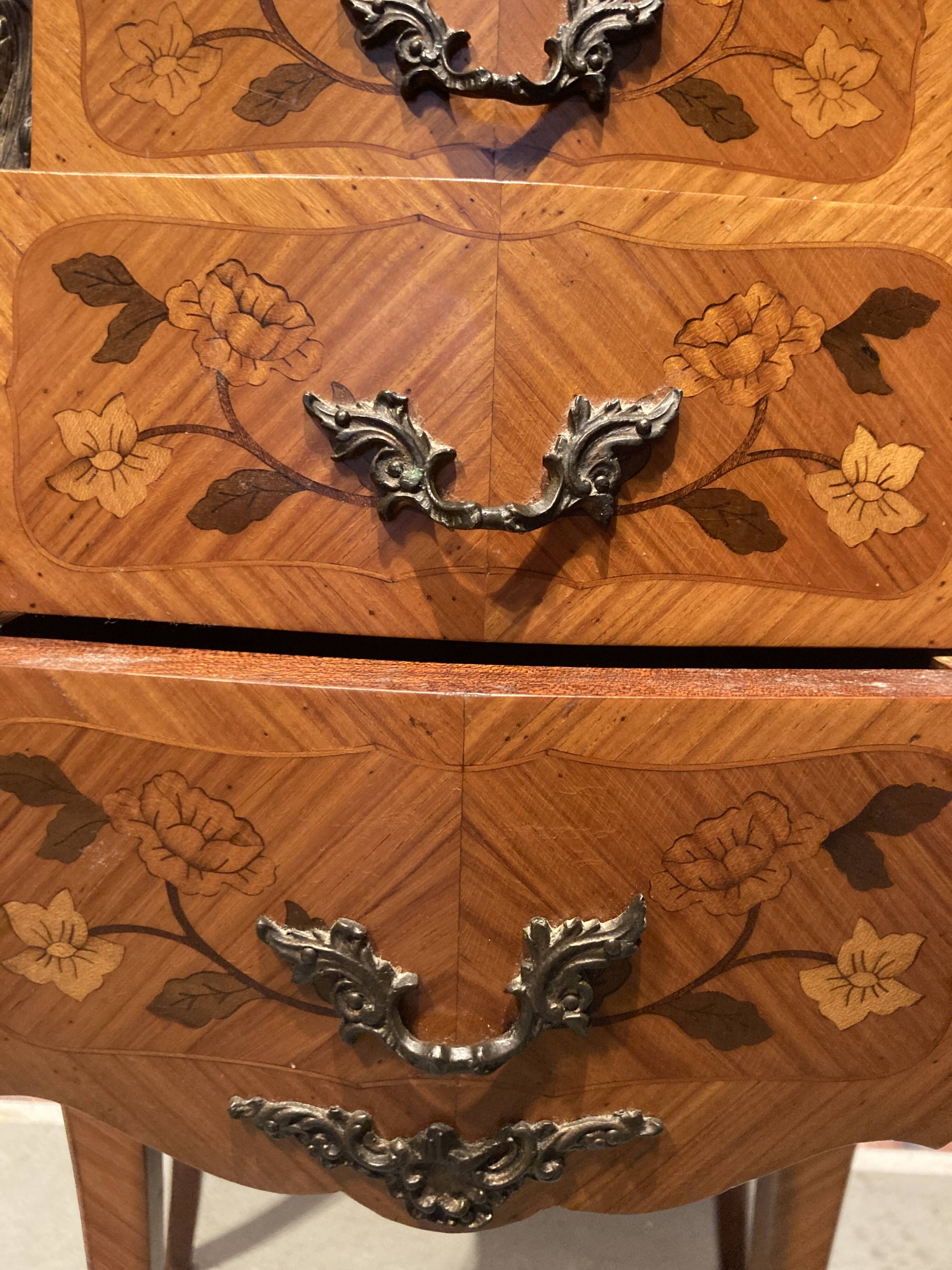 Wooden bedside table topped with a pink marble top