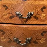 Wooden bedside table topped with a pink marble top