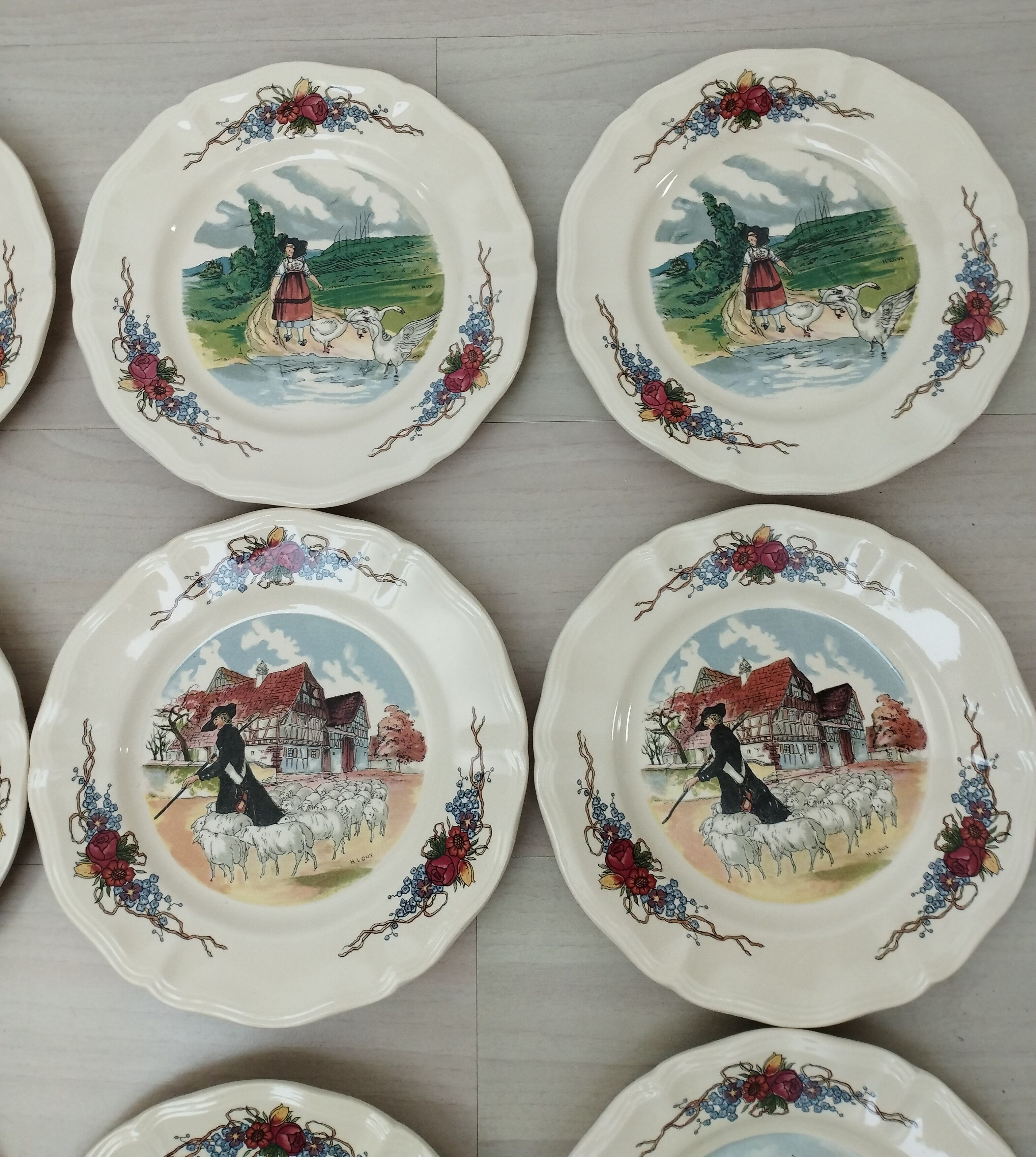 12 plates of the Obernai earthenware décor service signed Henri Loux