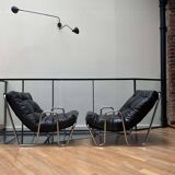 Pair of vintage armchairs in black imitation leather and chrome metal, France 1970