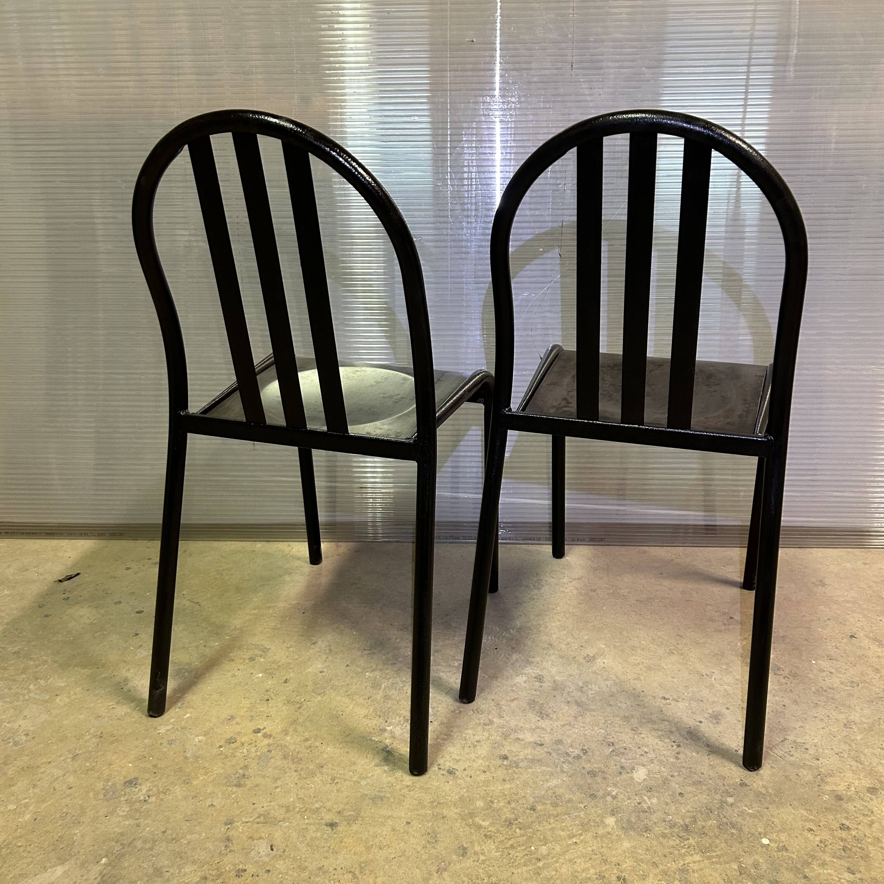 Two vintage slatted chairs.