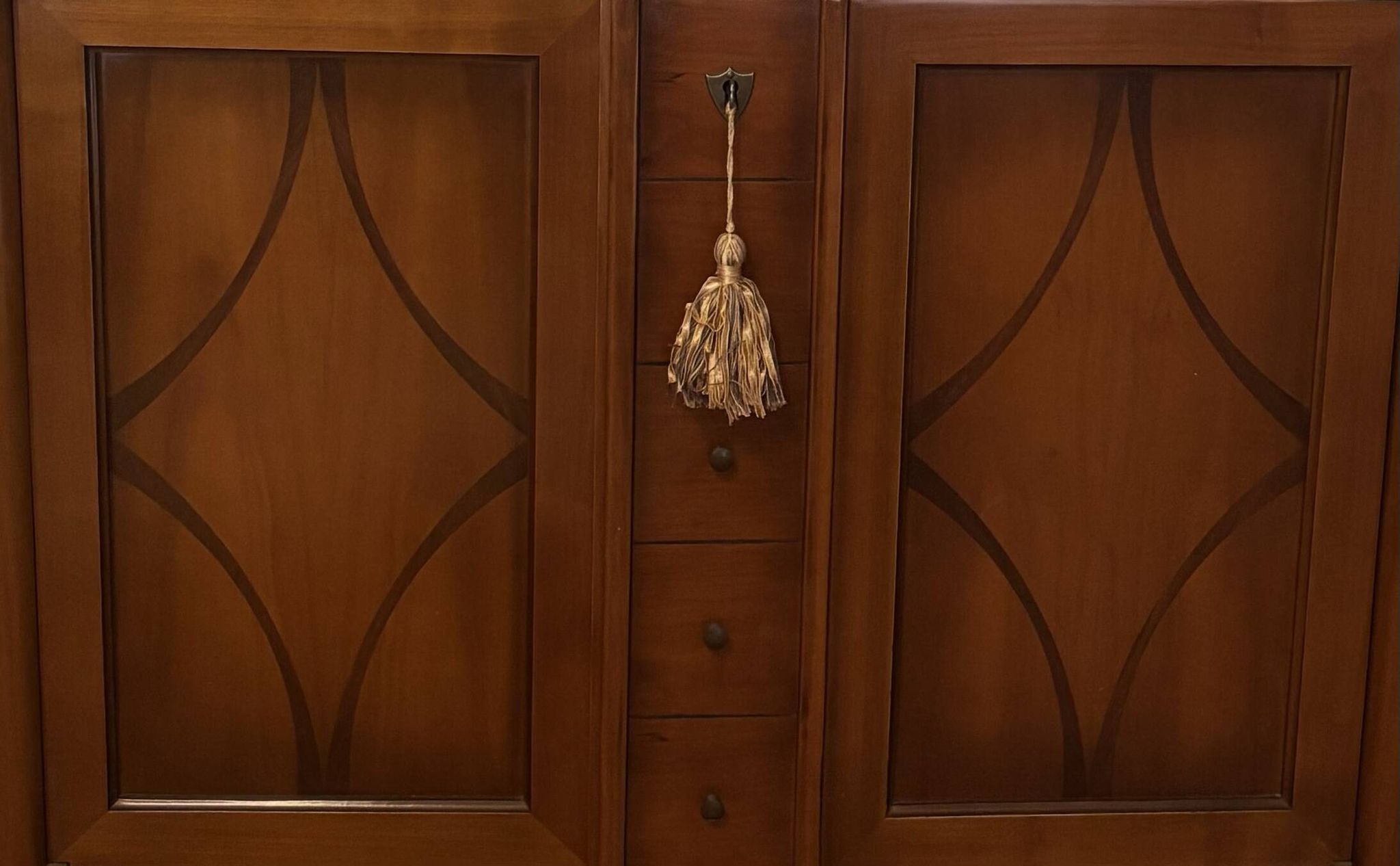 Vintage drop-leaf secretary with a green leather top and inlays.