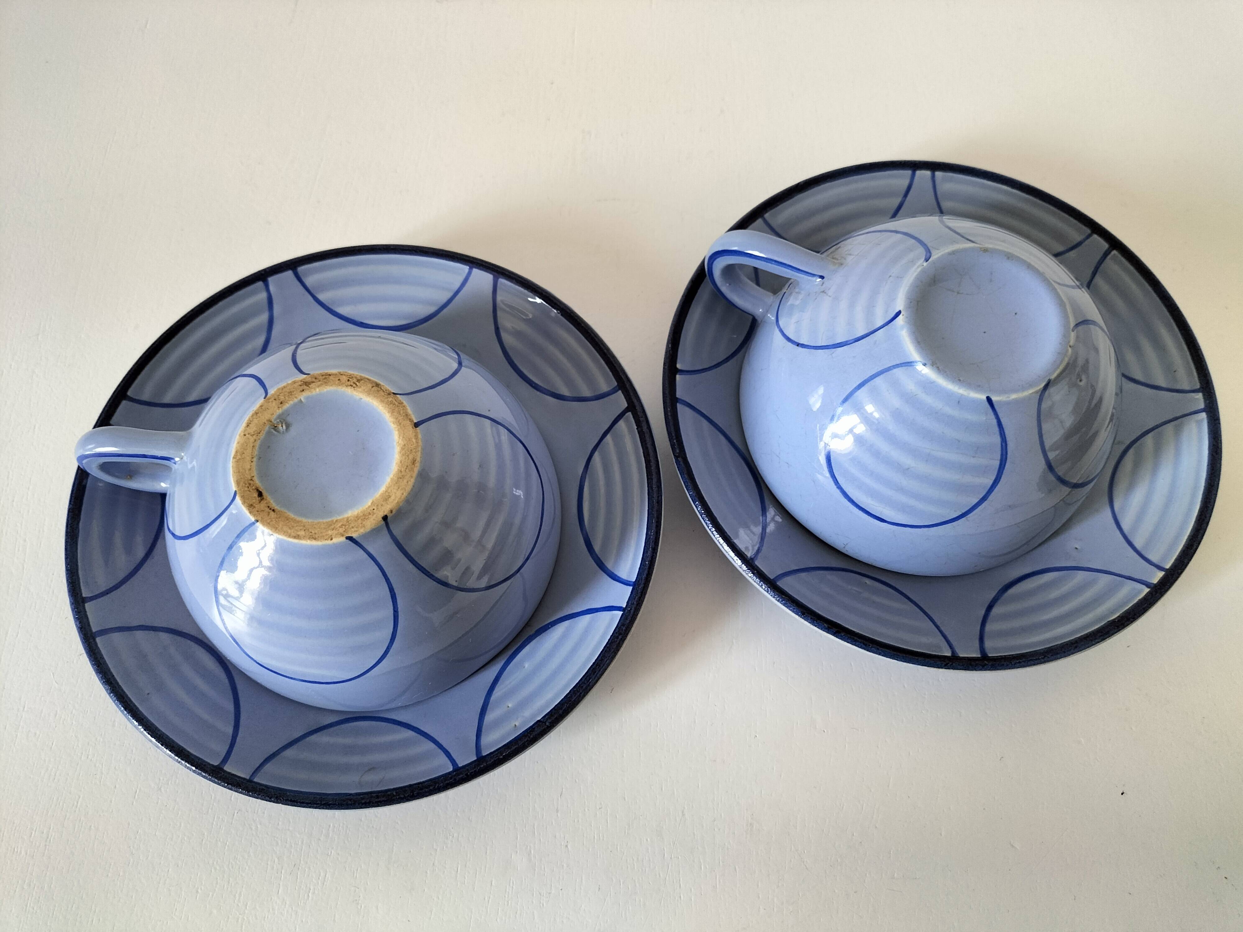 A pair of glazed ceramic cups and saucers from the 60s-70s.