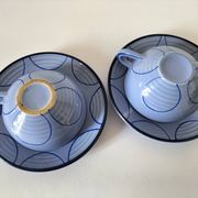 A pair of glazed ceramic cups and saucers from the 60s-70s.