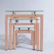 Three nesting tables from the 90s made of painted metal and tempered glass.