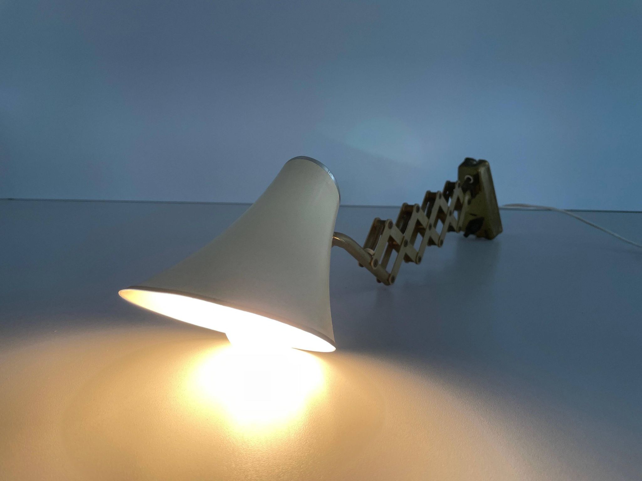 Cream metal and brass wall lamp with scissors design by Karl Lang for SIS Licht, 1950s, Germany.