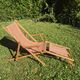 vintage wooden deck chair with striped fabric and footrest