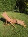 vintage wooden deck chair with striped fabric and footrest
