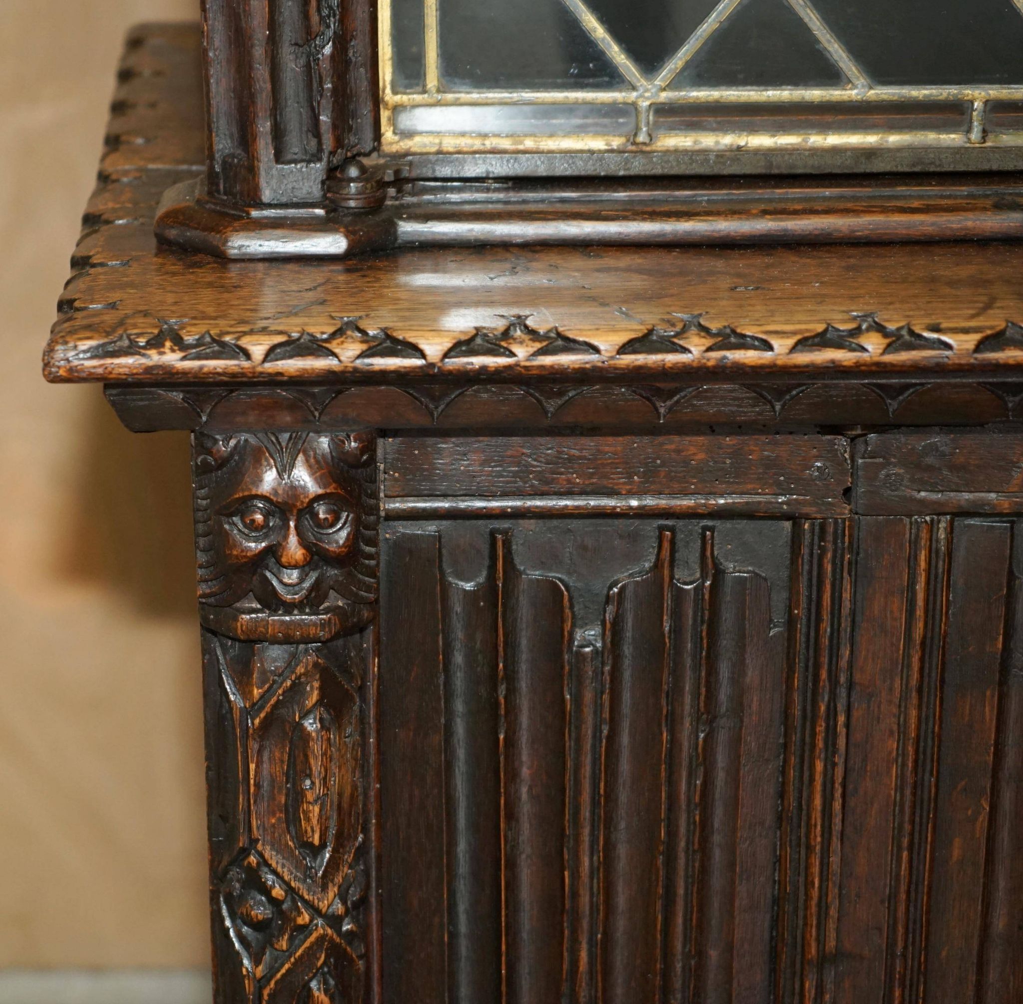 Jacobean hardwood library with carved panels and glass doors.