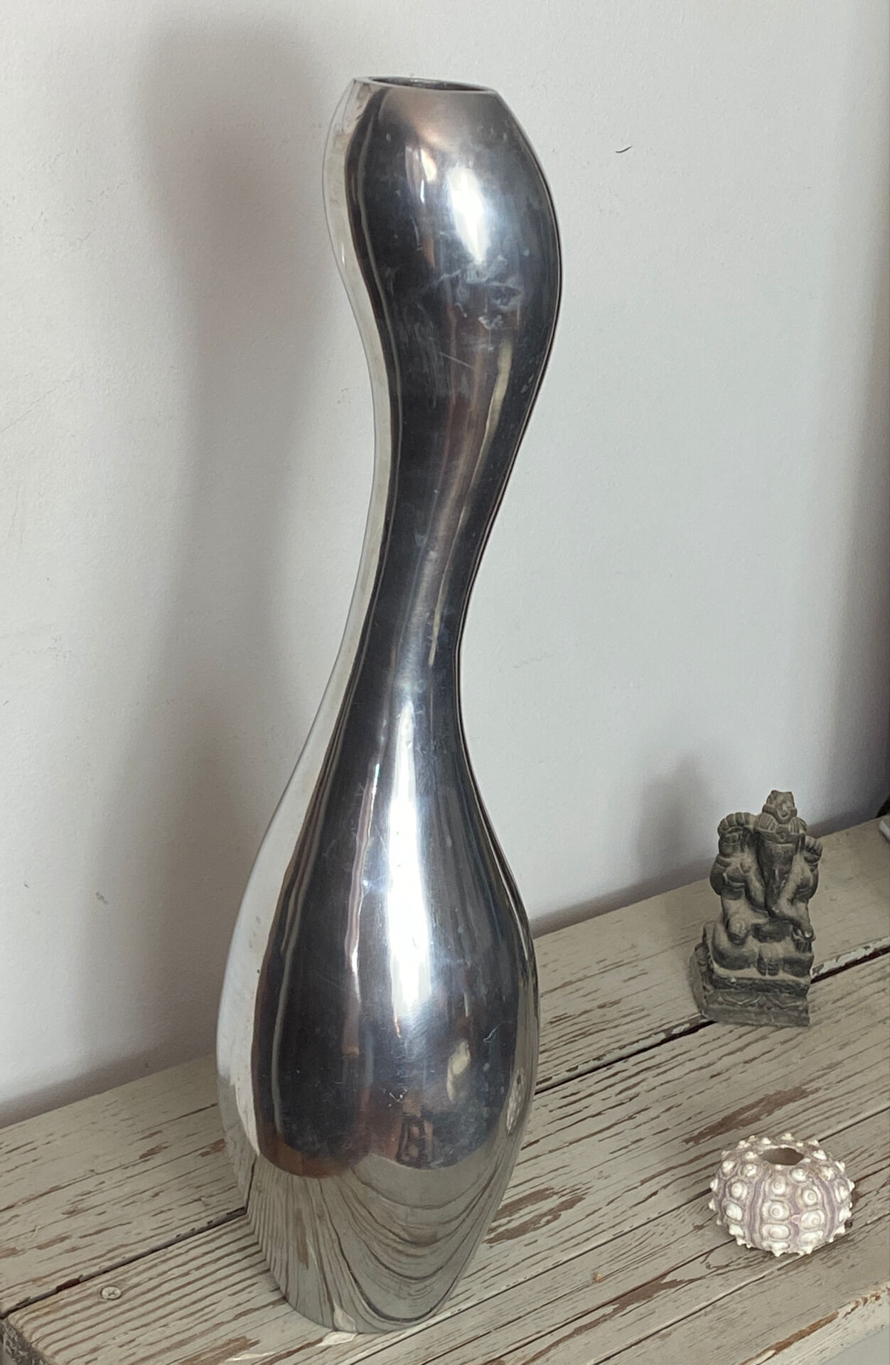 Large organic vase in polished aluminium cast.