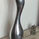 Large organic vase in polished aluminium cast.