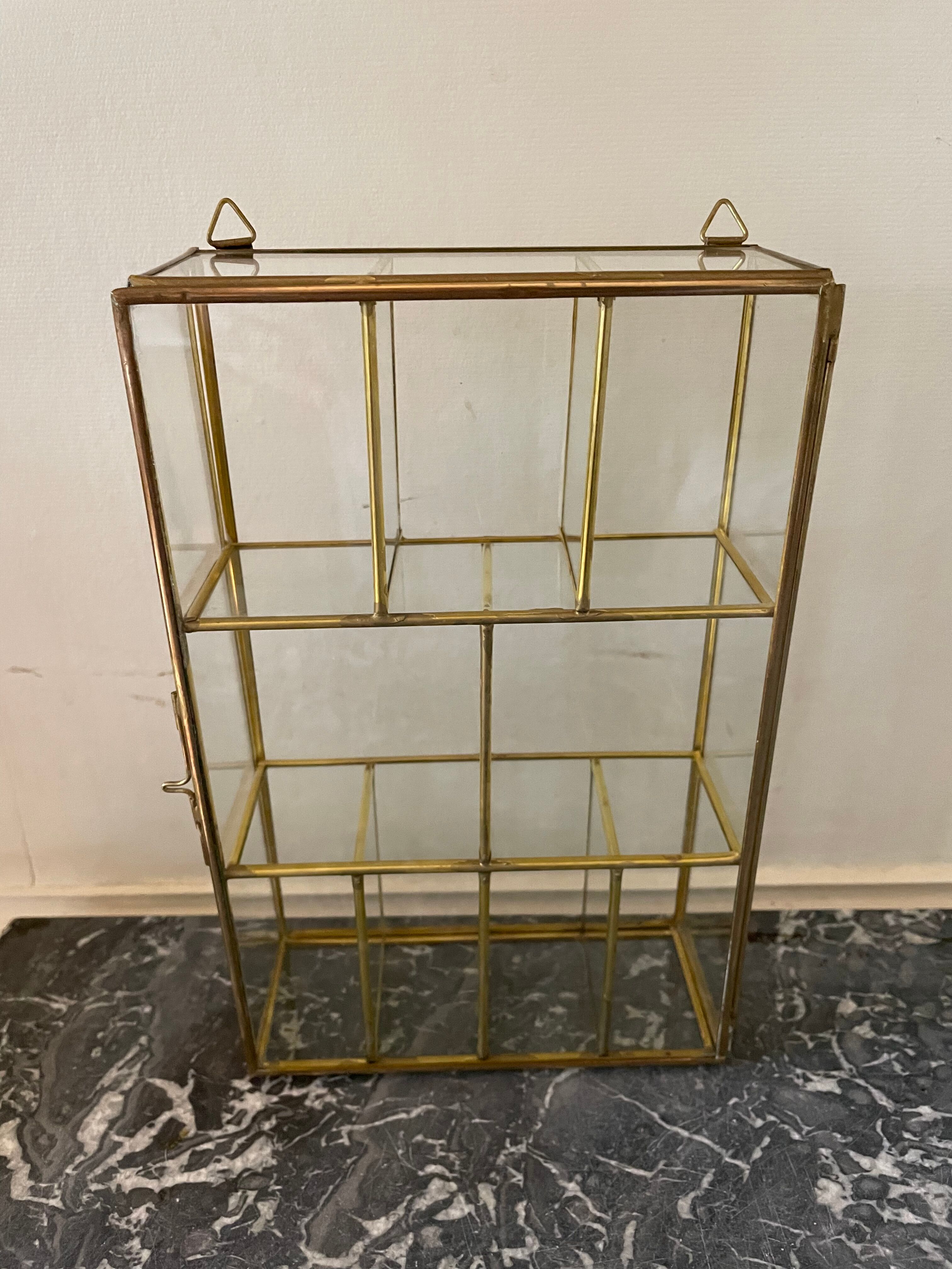 Glass and brass wall display case