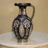 A jar of water pitcher made of tamgroute pottery handmade and adorned with bones.