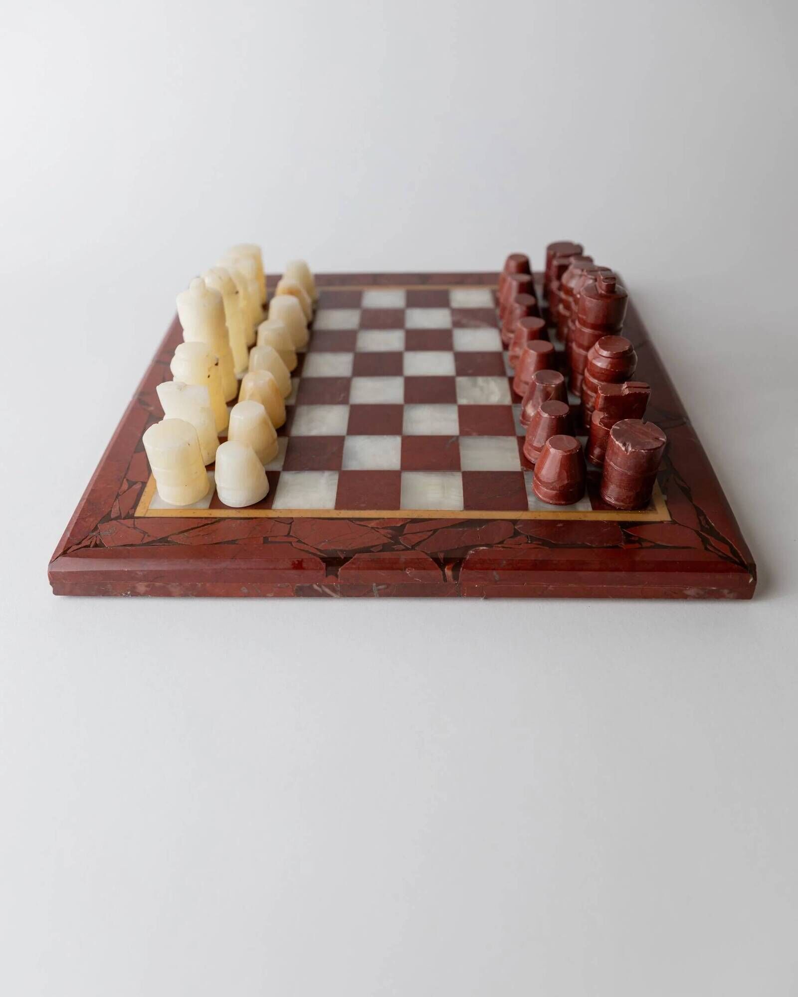 Vintage marble chess set from the 1960s, cream, burgundy and gold board with metal inlay, stone pieces.