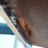 Chrome metal chairs and black faux leather upholstery in retro modernist style.