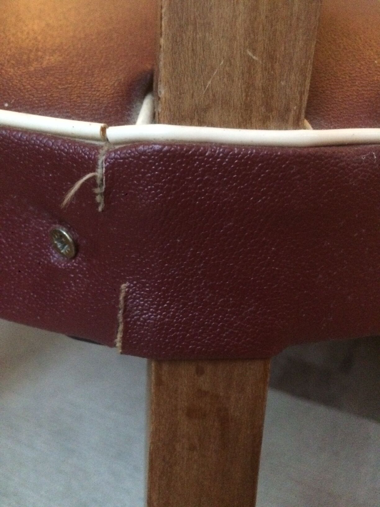 Skai chair binds wine and wooden footpieces and armrests