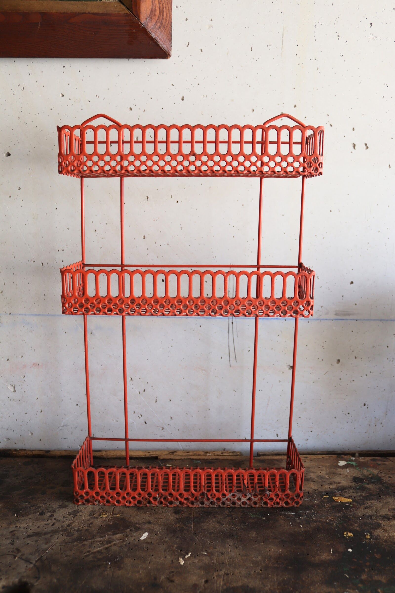 Vintage shelf in red openwork metal