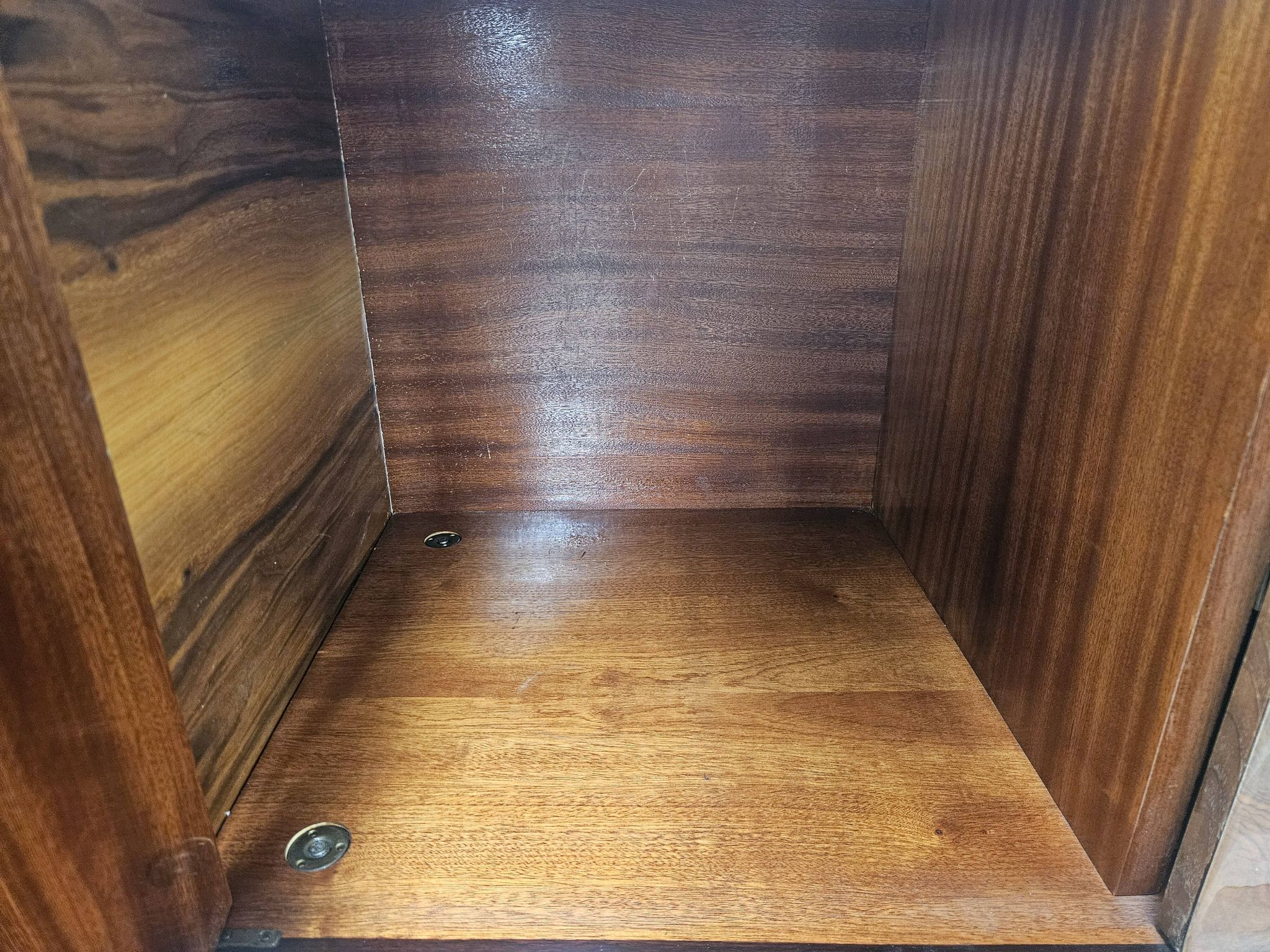 1950s mahogany sideboard with a glass top and central bar.