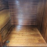 1950s mahogany sideboard with a glass top and central bar.