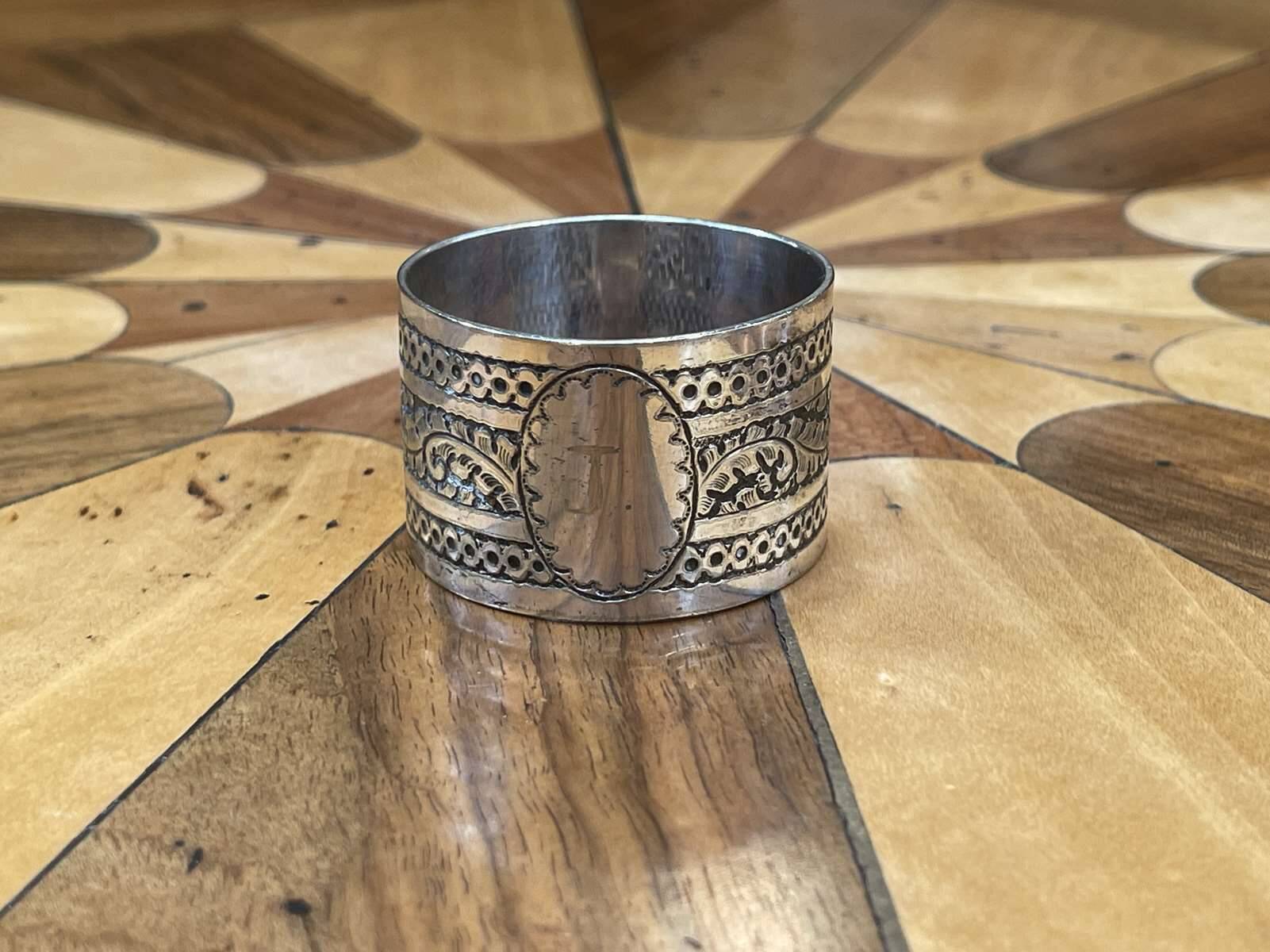Silver metal napkin ring with the letter J