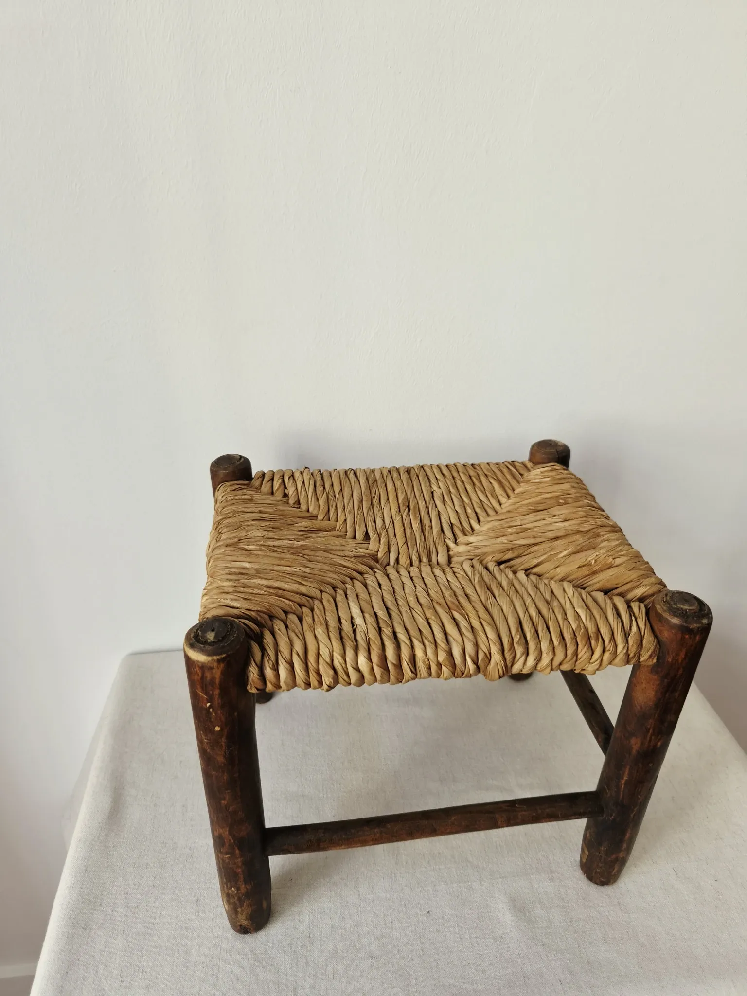 Small rustic vintage wooden and straw stool -