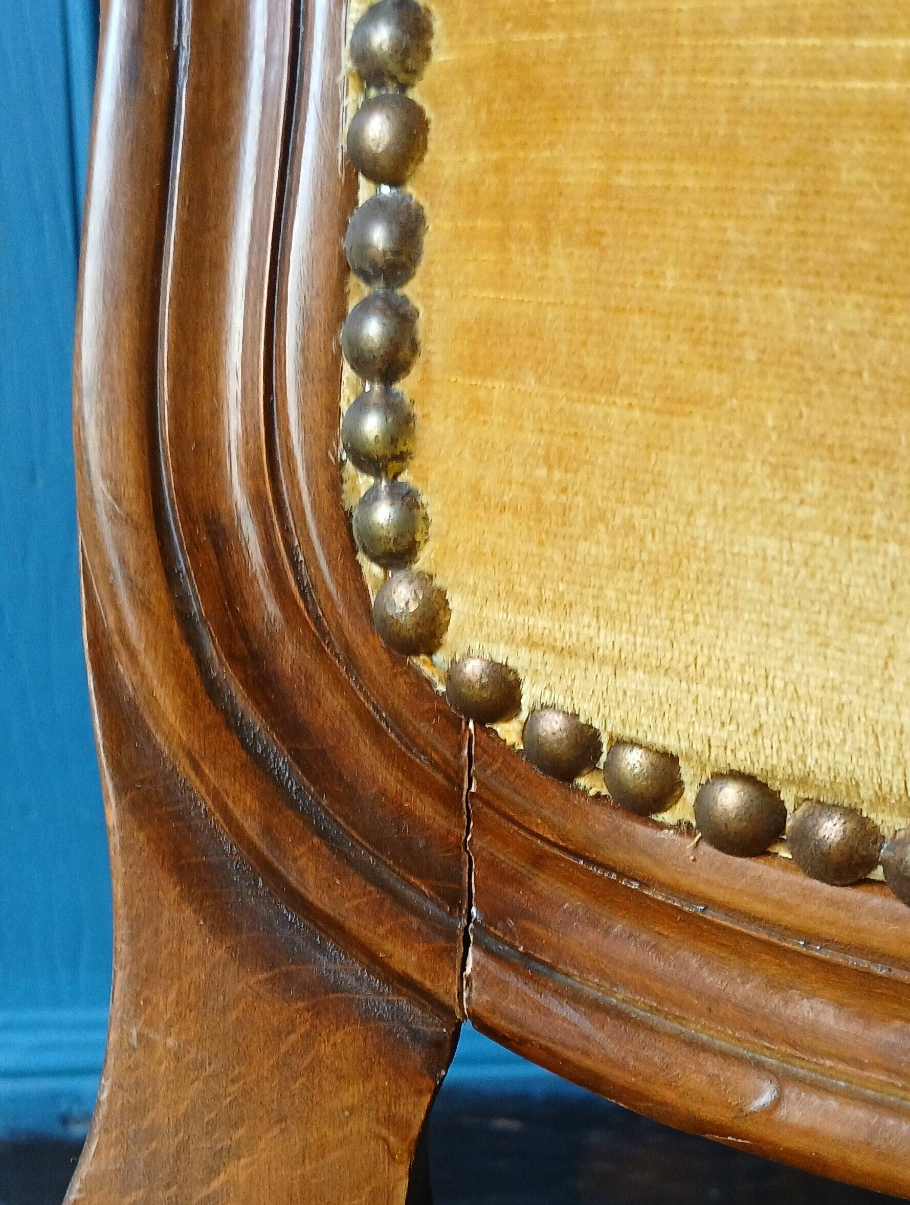 Velvet cabriolet armchair with decorative copper studs.
