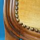 Velvet cabriolet armchair with decorative copper studs.