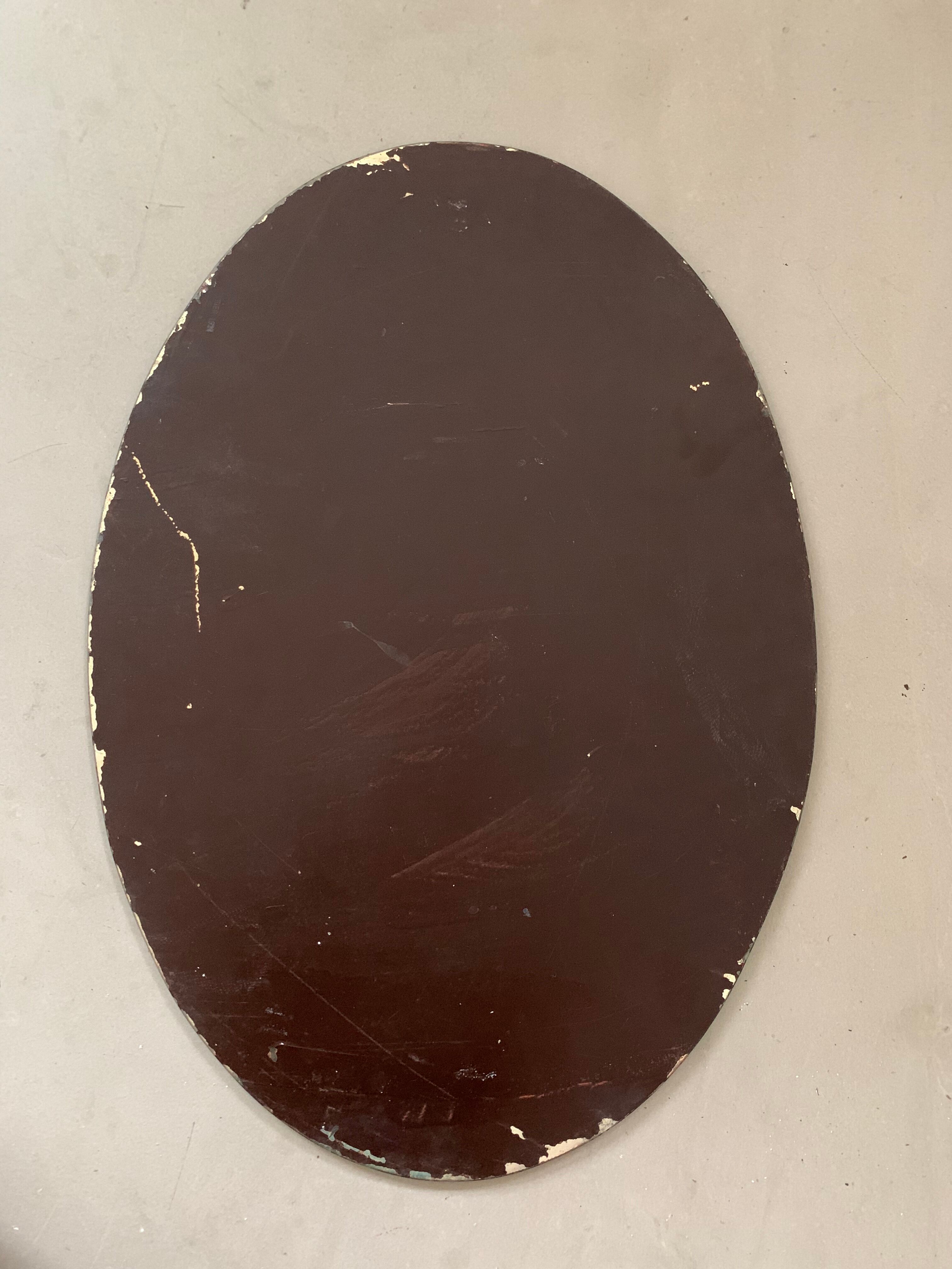 Old bevelled stitched oval mirror