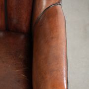 Unique sheepskin armchair with warm deep colours finished with black piping