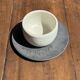 White Indonesian ceramic cup and gray saucer