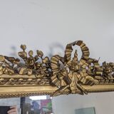 Golden Louis XVI style mirror with bouquet and shells.