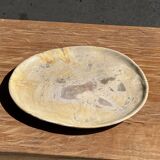Petrified wood catchall or dish in beige with several grey spots in the centre.